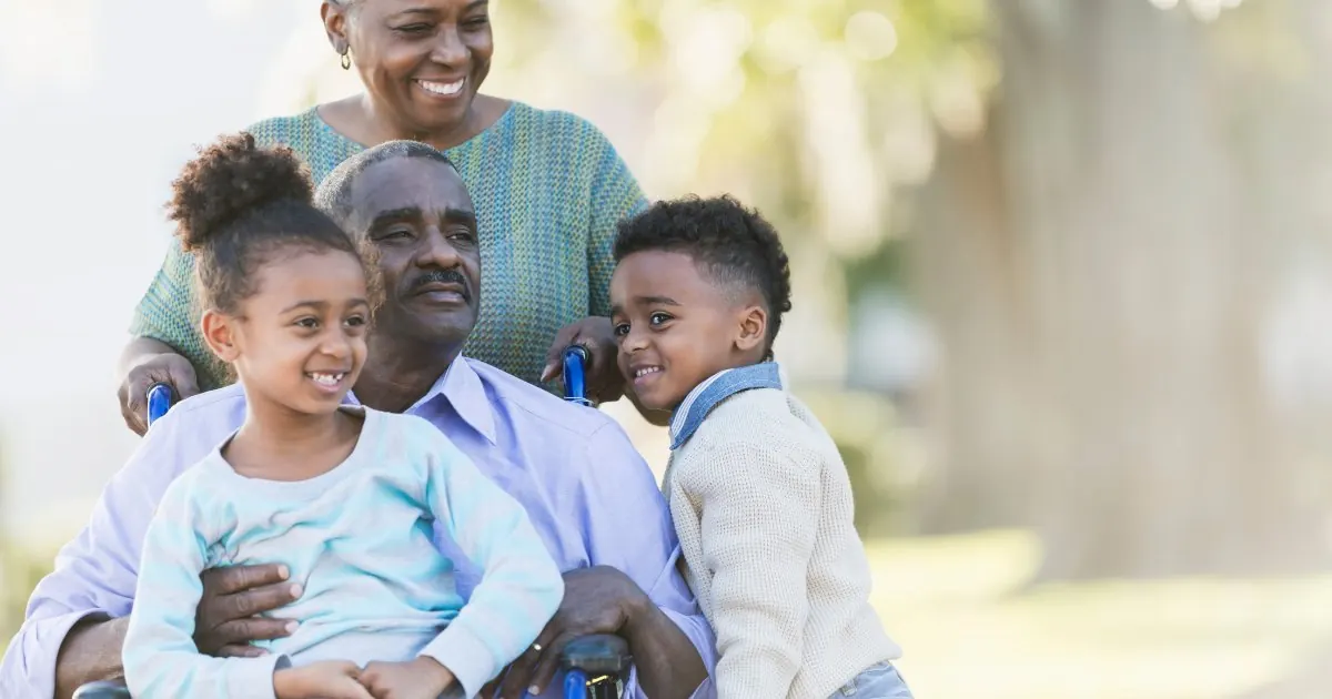 A grandfather sitting outdoors with two grandchildren — wills and providing for a family