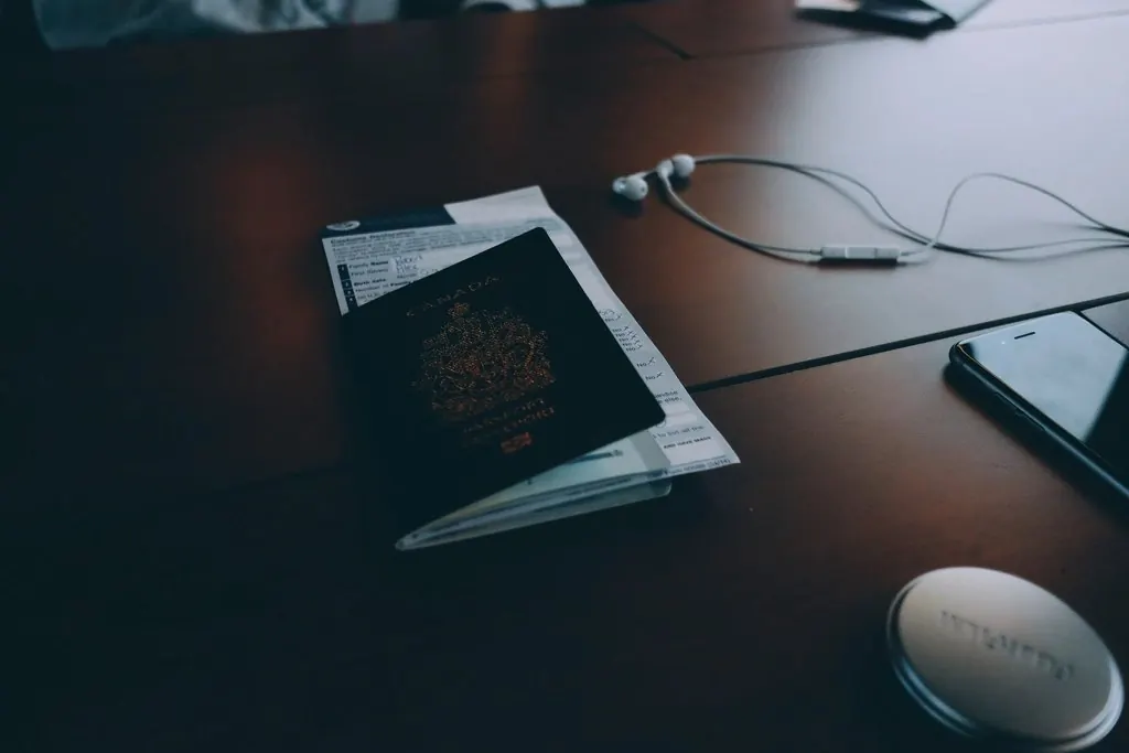 A passport and papers on a dark desk — immigration law and work permits in Trinidad and Tobago