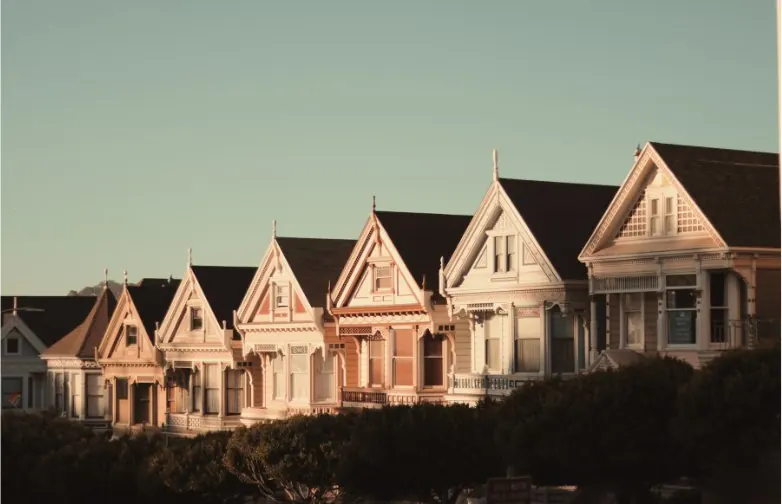 A row of painted timber houses — homes, tenancies and property tax